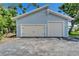 A detached garage with a two-car garage door and a single car garage door at 7815 16Th Nw Ave, Bradenton, FL 34209