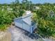 A detached garage with room for three cars surrounded by mature trees and a sunny sky at 7815 16Th Nw Ave, Bradenton, FL 34209