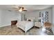 Bedroom featuring tile floors, a ceiling fan, patio door, and matching dressers at 7815 16Th Nw Ave, Bradenton, FL 34209