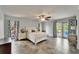 Spacious main bedroom with decorative curtains, tile floors, and a patio door at 7815 16Th Nw Ave, Bradenton, FL 34209