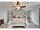 Bright main bedroom with matching dressers, tile floors, ceiling fan, and decor at 7815 16Th Nw Ave, Bradenton, FL 34209