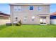 Expansive backyard featuring well-maintained lawn, sliding glass door, and privacy fence at 8111 Brickleton Woods Ave, Gibsonton, FL 33534
