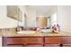 Bathroom featuring granite countertop, modern sink, and large mirror at 8111 Brickleton Woods Ave, Gibsonton, FL 33534