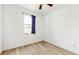 Minimalist bedroom design with wood-look vinyl floors and window with privacy at 8111 Brickleton Woods Ave, Gibsonton, FL 33534