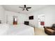 Neutral bedroom features a ceiling fan, white walls, and attached bathroom and doorway at 8111 Brickleton Woods Ave, Gibsonton, FL 33534