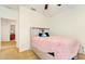 Carpeted bedroom with a white headboard, pink fuzzy blanket, and ceiling fan at 8111 Brickleton Woods Ave, Gibsonton, FL 33534