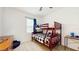 Bedroom with carpet features a wooden bunk bed with matching furniture and a ceiling fan at 8111 Brickleton Woods Ave, Gibsonton, FL 33534