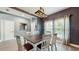 Neutral dining room showcasing a new table set, light fixture, and new flooring at 8111 Brickleton Woods Ave, Gibsonton, FL 33534