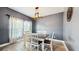 Modern dining room featuring a rustic light fixture, neutral paint, and new flooring at 8111 Brickleton Woods Ave, Gibsonton, FL 33534