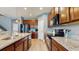 Modern kitchen featuring granite countertops, stainless steel appliances, and wooden cabinets at 8111 Brickleton Woods Ave, Gibsonton, FL 33534