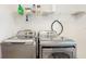 Laundry room showcasing modern washer and dryer set with shelf for storage at 8111 Brickleton Woods Ave, Gibsonton, FL 33534