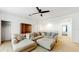 Comfortable living room includes modern sectional sofa and hardwood cabinet at 8111 Brickleton Woods Ave, Gibsonton, FL 33534