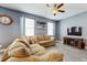 Inviting living room with a large sectional sofa, modern floors, and a cozy fireplace at 8111 Brickleton Woods Ave, Gibsonton, FL 33534