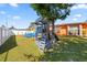 Backyard with a wooden playset and slide, offering a fun and engaging space for activities at 8216 Damara Dr, New Port Richey, FL 34653