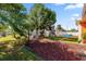 Spacious backyard featuring a playset, lush lawn, seating area and well-maintained landscaping at 8216 Damara Dr, New Port Richey, FL 34653
