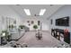 Bright and airy living room with vaulted ceilings, skylights, plush carpet, and neutral-toned furniture at 8216 Damara Dr, New Port Richey, FL 34653