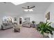 Spacious living room featuring neutral paint, carpet, vaulted ceilings, and a view of the arched front window at 8216 Damara Dr, New Port Richey, FL 34653
