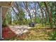 Shaded backyard with a concrete patio and a grill at 8619 Gold Pine Dr, Port Richey, FL 34668