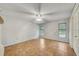 Large bedroom with tile flooring, two windows with blinds, and a ceiling fan at 8619 Gold Pine Dr, Port Richey, FL 34668