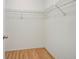 Walk-in closet with hardwood floors and wire shelving for storage at 8619 Gold Pine Dr, Port Richey, FL 34668