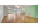 Spacious living area with tiled flooring, ceiling fans, and an open layout to the kitchen at 8619 Gold Pine Dr, Port Richey, FL 34668