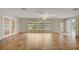 Spacious living room with large windows, tile flooring, and lots of natural light at 8619 Gold Pine Dr, Port Richey, FL 34668