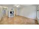 Spacious living room featuring tiled floors, a TV stand, and a ceiling fan at 8619 Gold Pine Dr, Port Richey, FL 34668