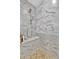 Bathroom shower featuring pebble flooring, marble tile, and showerhead at 9136 Warm Springs Cir, Parrish, FL 34219