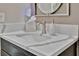 Bathroom features a modern sink with white marble countertop and gray vanity with matching mirror and lighting at 9136 Warm Springs Cir, Parrish, FL 34219