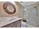 Bathroom features a modern sink with white marble countertop, gray vanity, and updated glass walk-in shower at 9136 Warm Springs Cir, Parrish, FL 34219