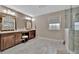 Bathroom with and vanities, elegant tile flooring, and glass shower at 9136 Warm Springs Cir, Parrish, FL 34219