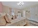 Comfortable bedroom with plush pillows, patterned bedding, and a bright window view at 9136 Warm Springs Cir, Parrish, FL 34219