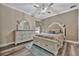 Bright bedroom features white furniture, neutral walls, and light-colored wood-look flooring, with plenty of sunlight at 9136 Warm Springs Cir, Parrish, FL 34219