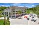 Exterior shot of the community clubhouse offering tables, chairs, and a vibrant, modern architectural style at 9136 Warm Springs Cir, Parrish, FL 34219