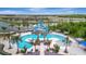 Top down shot of a community pool with multiple areas, a waterslide, and ample lounging at 9136 Warm Springs Cir, Parrish, FL 34219