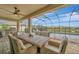Relaxing covered patio area with ceiling fan, ample seating, BBQ and view of private pool at 9136 Warm Springs Cir, Parrish, FL 34219