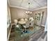 Formal dining room with hardwood floors, stylish furniture, elegant chandelier, and decorative rug at 9136 Warm Springs Cir, Parrish, FL 34219