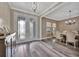 Entryway view into the dining room with a large doorway, chandelier and hardwood floors at 9136 Warm Springs Cir, Parrish, FL 34219