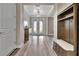 Bright entryway boasts double glass doors, luxury vinyl flooring, and a built-in storage bench at 9136 Warm Springs Cir, Parrish, FL 34219