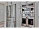 Modern kitchen featuring stainless steel refrigerator, ovens, and white cabinetry at 9136 Warm Springs Cir, Parrish, FL 34219