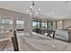 Bright kitchen island featuring stone countertops, modern lighting, and backyard views through sliding glass doors at 9136 Warm Springs Cir, Parrish, FL 34219