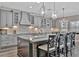 Modern kitchen with a large island, pendant lighting, and stainless steel appliances at 9136 Warm Springs Cir, Parrish, FL 34219