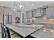 Bright kitchen features stainless appliances, stone countertops, tile backsplash and island seating at 9136 Warm Springs Cir, Parrish, FL 34219