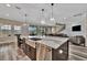 Spacious kitchen with large island, stainless steel appliances, and modern lighting at 9136 Warm Springs Cir, Parrish, FL 34219