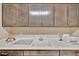 Well-organized laundry area with plenty of cabinets and counter space, perfect for household tasks at 9136 Warm Springs Cir, Parrish, FL 34219