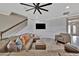 Cozy living room with plush seating, ceiling fan, and staircase at 9136 Warm Springs Cir, Parrish, FL 34219