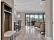Open-concept living space with sliding glass doors, modern furnishings, and luxury vinyl flooring at 9136 Warm Springs Cir, Parrish, FL 34219