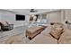 Spacious living room featuring a large sofa, TV, custom wall panels, and built-in indoor slide and play area at 9136 Warm Springs Cir, Parrish, FL 34219