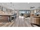 Spacious living area with modern kitchen, sliding glass doors, and luxury vinyl flooring at 9136 Warm Springs Cir, Parrish, FL 34219