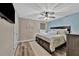 Comfortable main bedroom features a ceiling fan, ensuite bathroom, and light colored wood-look flooring at 9136 Warm Springs Cir, Parrish, FL 34219